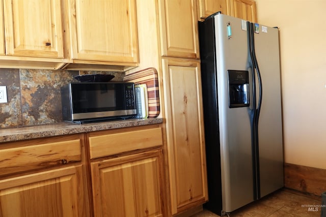 kitchen with stainless steel appliances and backsplash