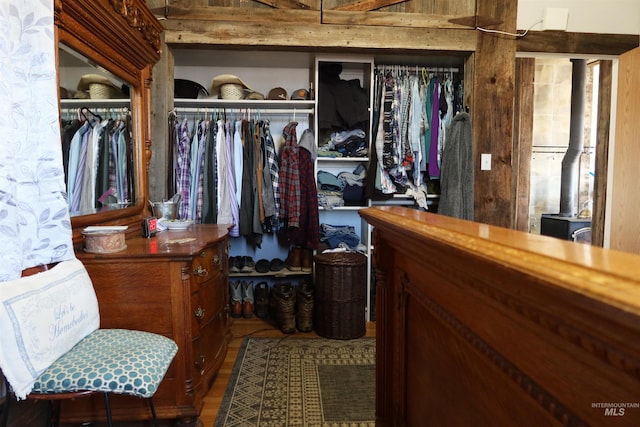walk in closet featuring a wood stove