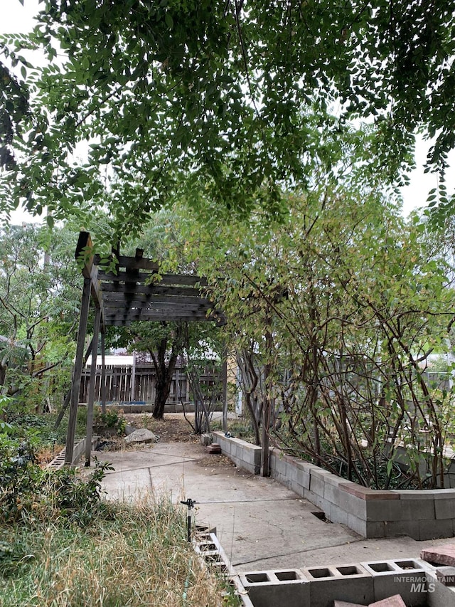 exterior space with fence and a pergola