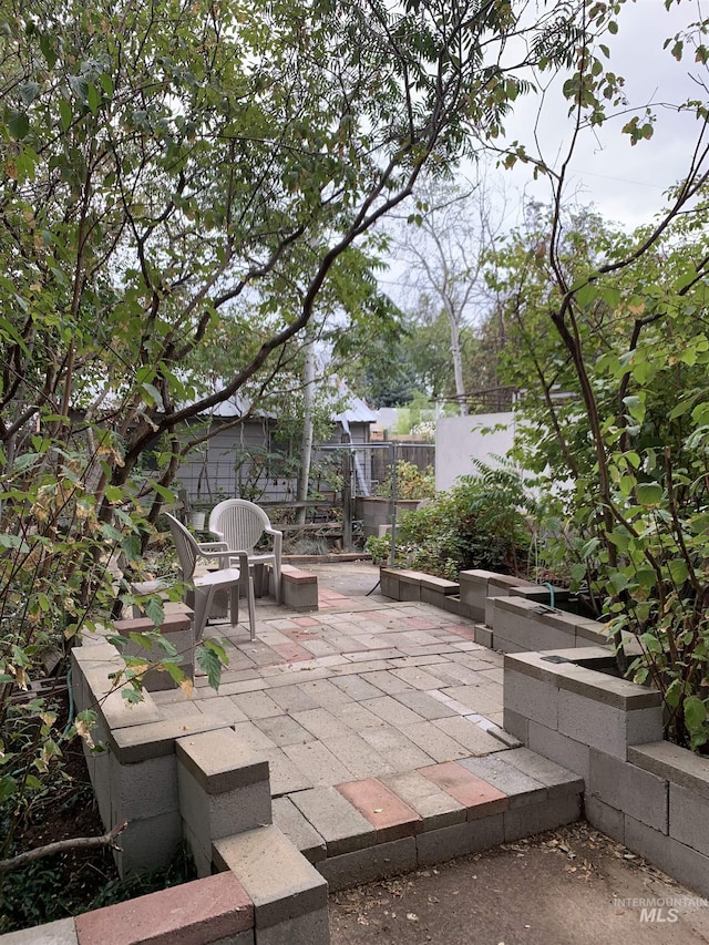 view of patio / terrace featuring fence