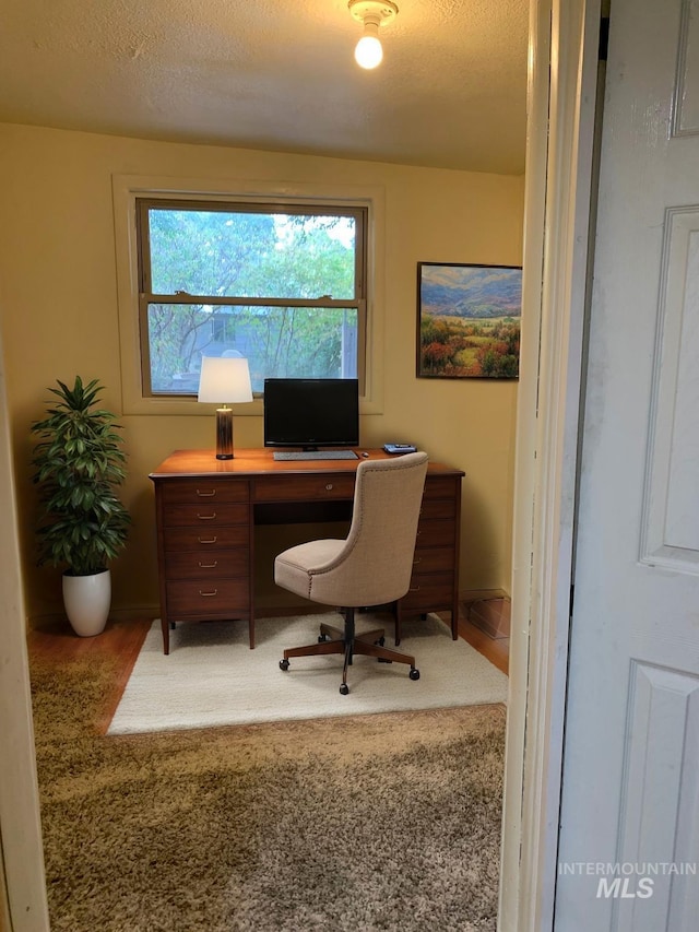 office area with a textured ceiling