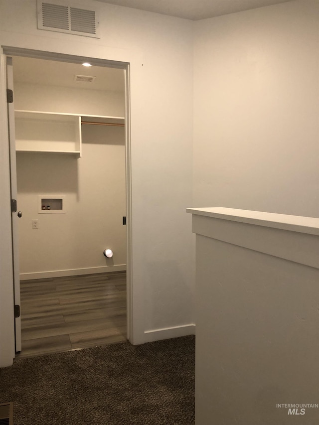 interior space with dark colored carpet and washer hookup