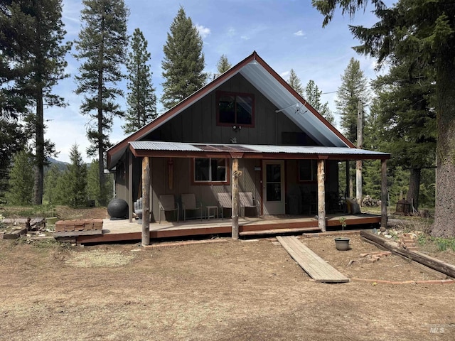 26 Doaka Ct, Idaho City, ID 83631 - back of property with board and batten siding, metal roof, and a deck