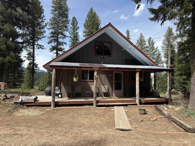 26 Doaka Ct, Idaho City, ID 83631 - rear view of house with board and batten siding, metal roof, and covered porch