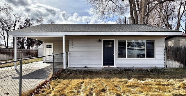 view of front of property featuring fence and a shingled roof