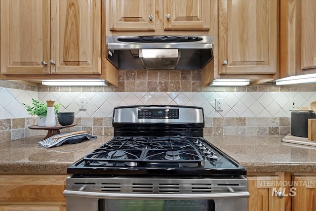 kitchen with tasteful backsplash, stainless steel range with gas cooktop, light brown cabinetry, and exhaust hood