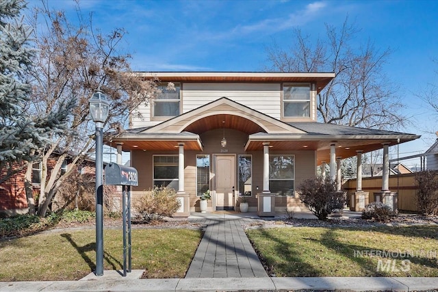 view of front of property with a porch and a front lawn