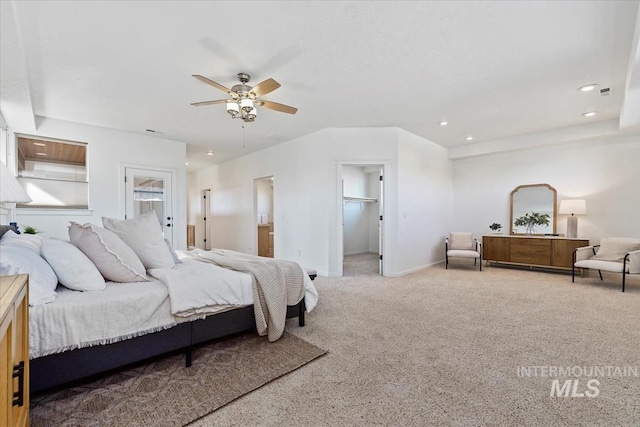 bedroom with carpet floors, a walk in closet, recessed lighting, a ceiling fan, and baseboards