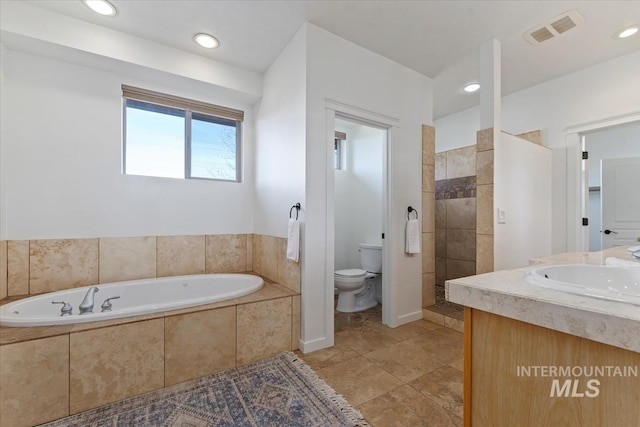 bathroom featuring visible vents, toilet, walk in shower, a bath, and recessed lighting