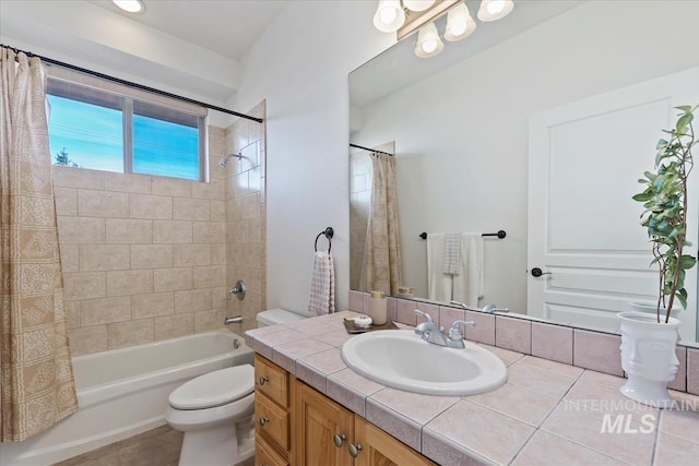 bathroom with tile patterned floors, vanity, toilet, and shower / bathtub combination with curtain