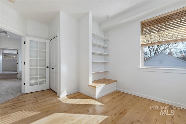 interior space featuring light wood-style floors and baseboards