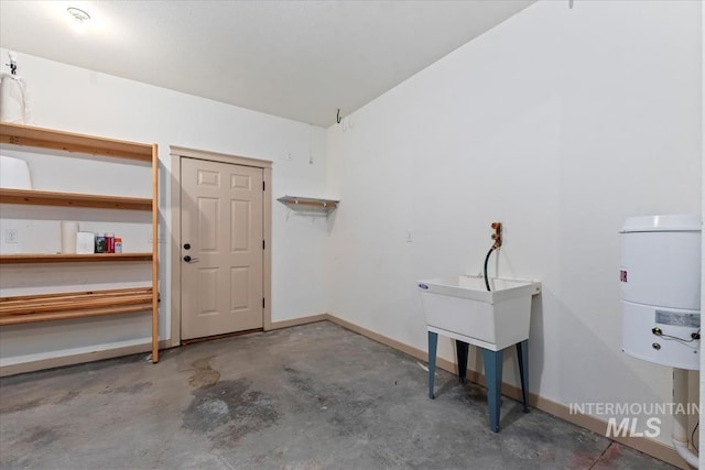 garage featuring water heater and baseboards