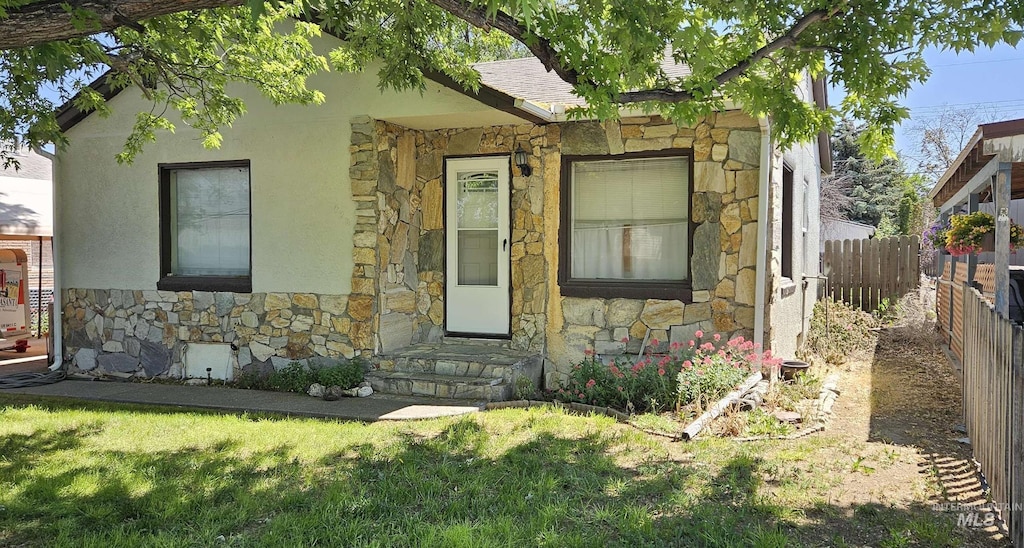 428 Martin St, Twin Falls, ID 83301 - view of front of home featuring stone siding, a shingled roof, and stucco siding