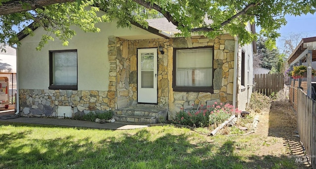 428 Martin St, Twin Falls, ID 83301 - view of front of home featuring stone siding, a shingled roof, and stucco siding
