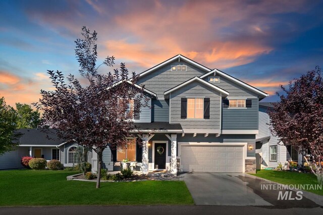 craftsman-style home with a garage and a lawn