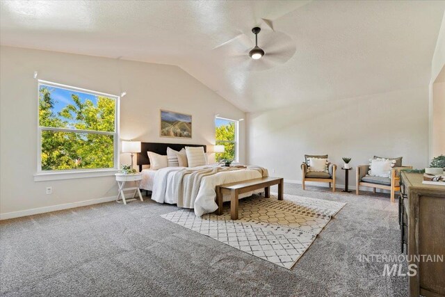 carpeted bedroom with ceiling fan and vaulted ceiling