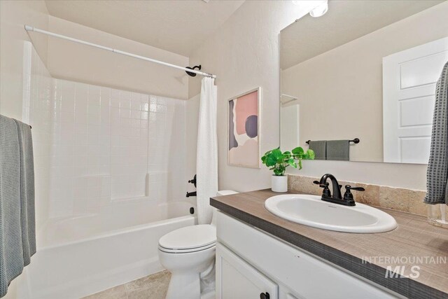 full bathroom featuring tile patterned floors, vanity, shower / bathtub combination with curtain, and toilet