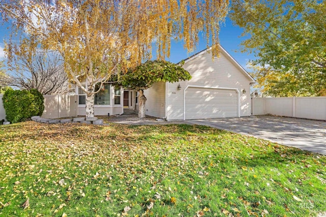 obstructed view of property featuring a front yard and a garage