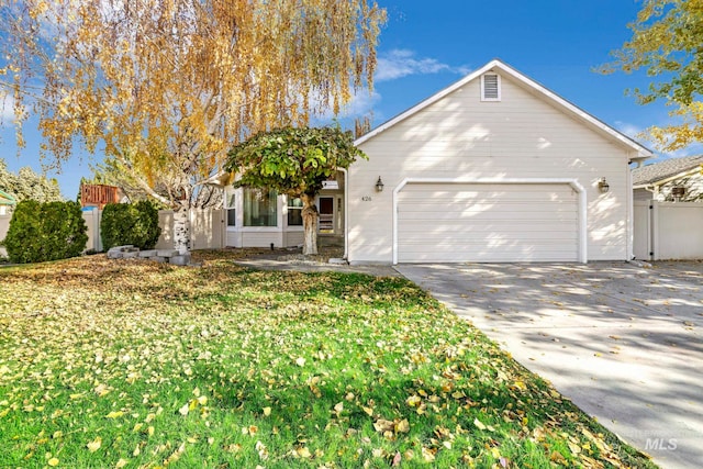 view of front of property featuring a front lawn and a garage