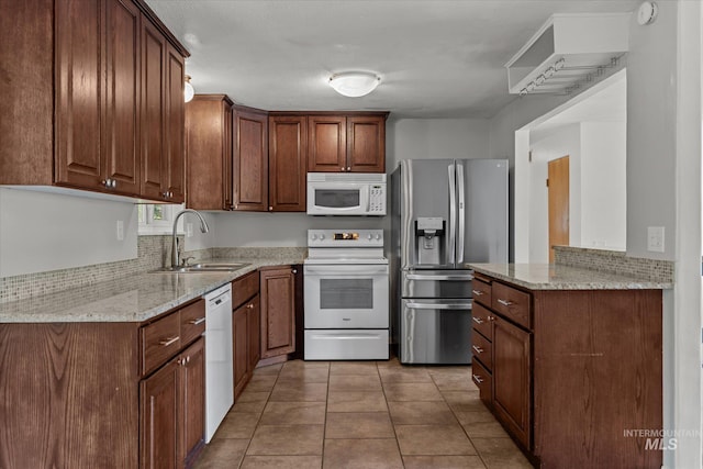 7313 W Court Ave, Boise, ID 83704 - kitchen featuring white appliances, a sink, light stone countertops, and light tile patterned floors