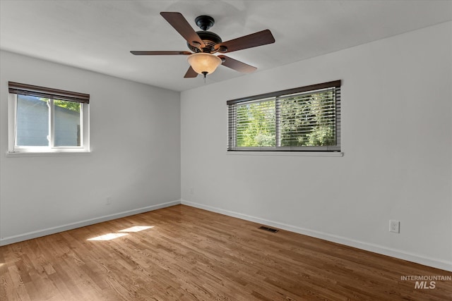 7313 W Court Ave, Boise, ID 83704 - unfurnished room with plenty of natural light, baseboards, and light wood-style flooring