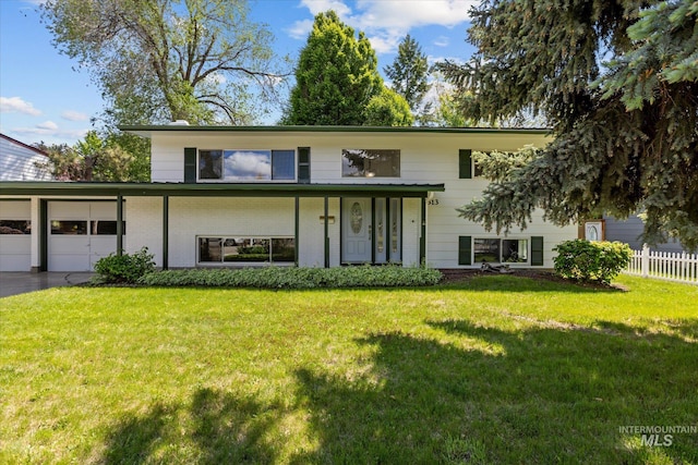 7313 W Court Ave, Boise, ID 83704 - view of front of house with brick siding, a garage, and driveway