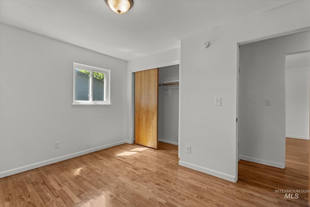 7313 W Court Ave, Boise, ID 83704 - unfurnished bedroom featuring a closet, baseboards, and wood finished floors