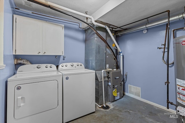 7313 W Court Ave, Boise, ID 83704 - laundry area featuring washer and clothes dryer, cabinet space, gas water heater, and baseboards