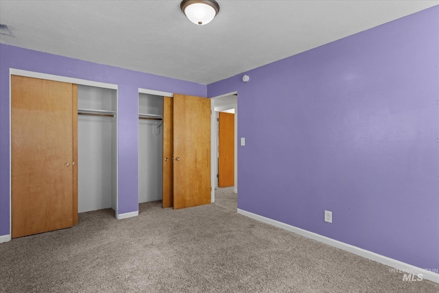 7313 W Court Ave, Boise, ID 83704 - unfurnished bedroom with carpet, multiple closets, and baseboards