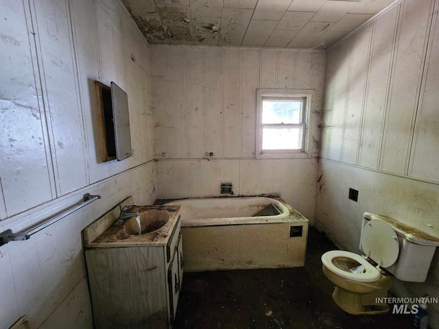 bathroom with vanity, a tub to relax in, toilet, and wood walls