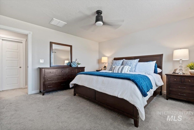 carpeted bedroom with visible vents, a ceiling fan, and baseboards