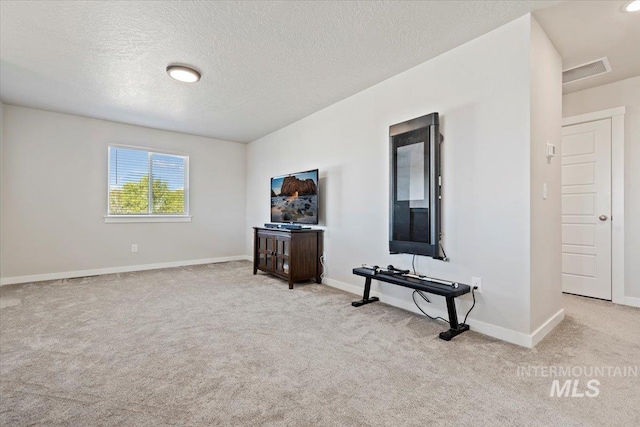 interior space with baseboards, carpet floors, and a textured ceiling