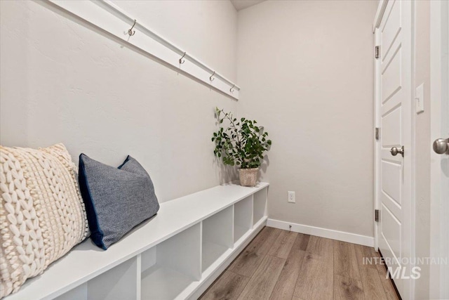 mudroom with wood finished floors and baseboards