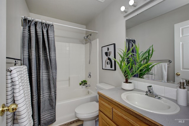 bathroom with shower / bathtub combination with curtain, toilet, and vanity