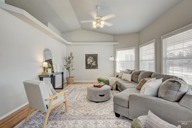 living room with wood finished floors, a ceiling fan, baseboards, and lofted ceiling