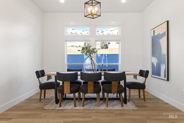 dining space featuring an inviting chandelier and wood-type flooring