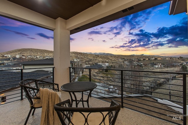 balcony at dusk with a mountain view