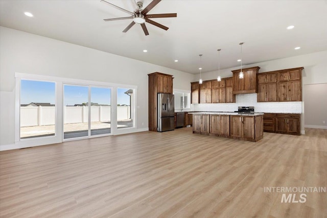 3119 Crescent Moon Rd, Twin Falls, ID 83301 - kitchen with stainless steel appliances, open floor plan, a kitchen island, ceiling fan, and light countertops