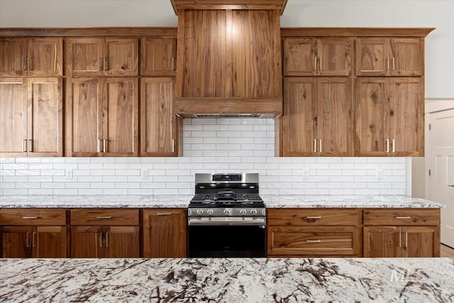 3119 Crescent Moon Rd, Twin Falls, ID 83301 - kitchen featuring stainless steel range with gas cooktop, brown cabinets, and backsplash