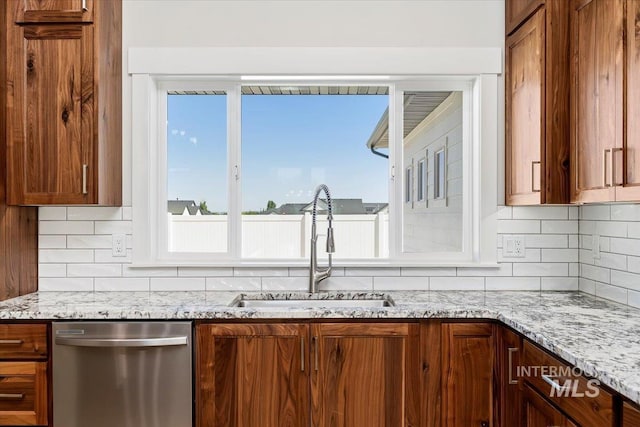 3119 Crescent Moon Rd, Twin Falls, ID 83301 - kitchen featuring dishwasher, tasteful backsplash, plenty of natural light, and brown cabinetry