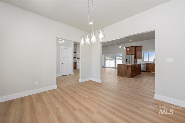 3119 Crescent Moon Rd, Twin Falls, ID 83301 - unfurnished living room featuring light wood-style floors and a chandelier