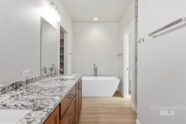 3119 Crescent Moon Rd, Twin Falls, ID 83301 - full bathroom featuring double vanity, wood finished floors, a soaking tub, and recessed lighting
