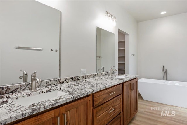 3119 Crescent Moon Rd, Twin Falls, ID 83301 - full bathroom with double vanity, a freestanding bath, and wood finished floors