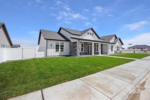 3119 Crescent Moon Rd, Twin Falls, ID 83301 - rear view of house with board and batten siding, a gate, stone siding, and roof with shingles