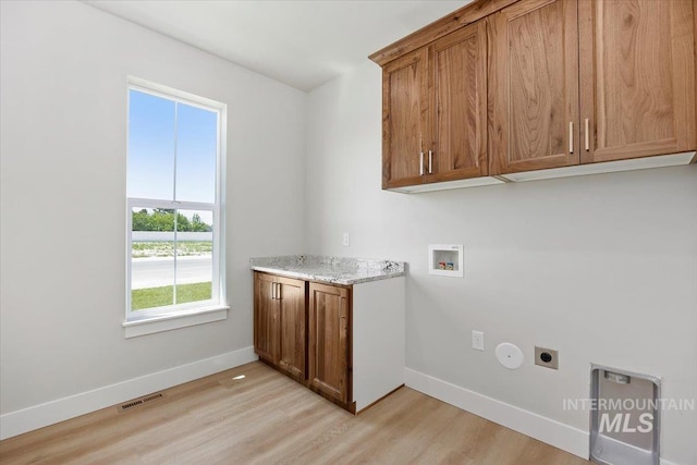 3119 Crescent Moon Rd, Twin Falls, ID 83301 - laundry room with cabinet space, electric dryer hookup, light wood-style flooring, and hookup for a washing machine