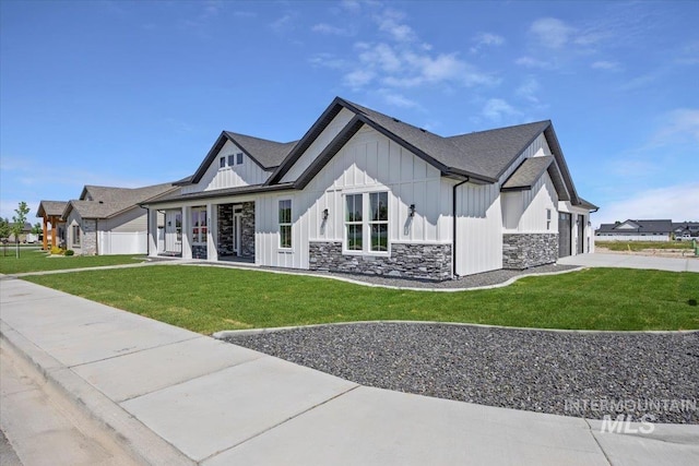 3119 Crescent Moon Rd, Twin Falls, ID 83301 - view of side of home featuring concrete driveway, board and batten siding, stone siding, an attached garage, and a lawn