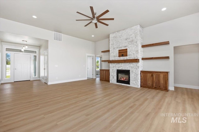 3119 Crescent Moon Rd, Twin Falls, ID 83301 - unfurnished living room featuring a ceiling fan, light wood finished floors, a towering ceiling, a fireplace, and recessed lighting