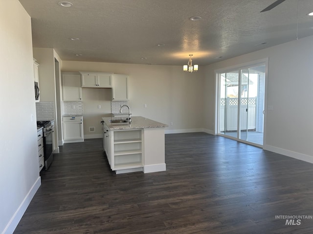 kitchen featuring a sink, dark wood finished floors, open shelves, and stainless steel range with gas stovetop