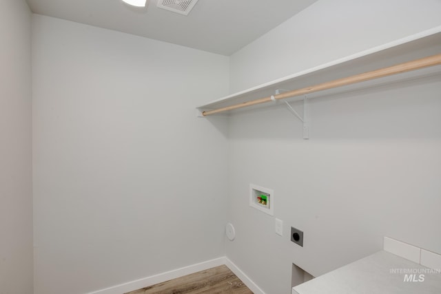 laundry area with washer hookup, visible vents, electric dryer hookup, wood finished floors, and laundry area