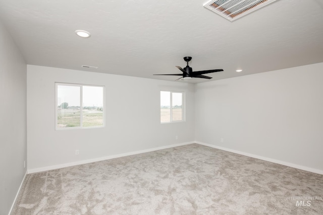 empty room with light colored carpet, visible vents, baseboards, and recessed lighting